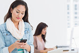 Woman text messaging in office
