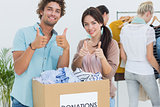 People with clothes donation gesturing thumbs up