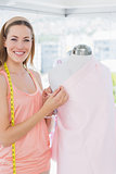 Female fashion designer working on pink fabric