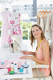Portrait of a female fashion designer working on fabrics