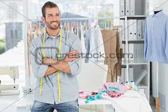 Smiling male fashion designer with arms crossed