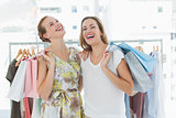 Cheerful women with shopping bags in the clothes store