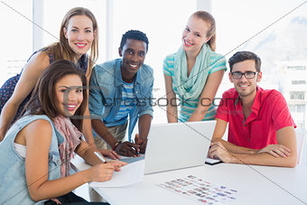 Young casual people using laptop in office