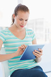 Beautiful young casual woman using digital tablet