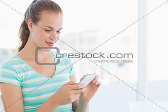 Beautiful young casual woman text massaging