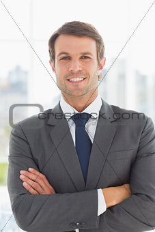 Portrait of a businessman with arms crossed outdoors