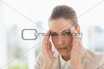 Closeup portrait of a young businesswoman with headache