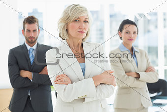 Confident business team with arms crossed in office