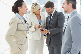 Business colleagues in discussion during office break