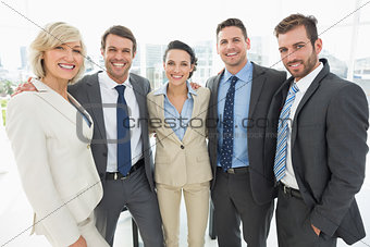 Confident business team standing together in office