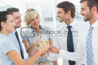 Business team toasting with champagne in office