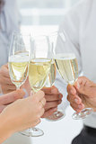Hands toasting with champagne