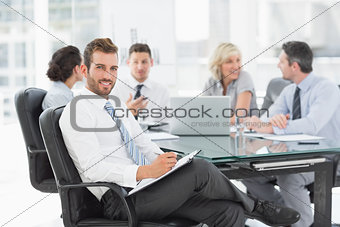 Young businessman with colleagues discussing in office