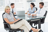 Young businesswoman with colleagues discussing in office