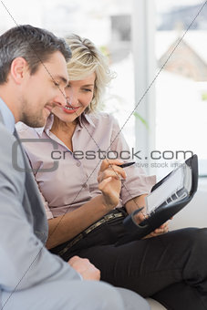 Businessman and his secretary  with diary at home