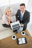 Businessman and his secretary with laptop and diary at home