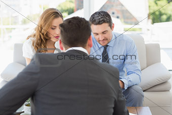 Couple in meeting with a financial adviser at home