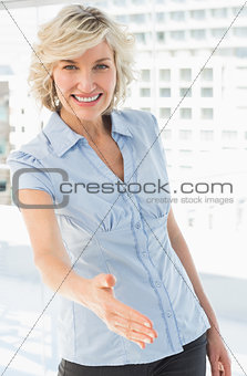 Portrait of an elegant businesswoman offering a handshake
