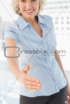 Elegant businesswoman offering a handshake