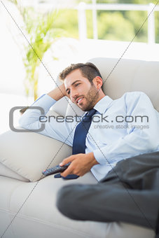 Well dressed man watching tv in living room