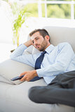 Relaxed well dressed man watching tv in living room
