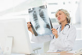 Female doctor examining xray in medical office