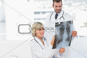Doctor explaining xray to her male colleague
