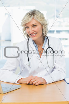 Female doctor sitting at desk in medical office