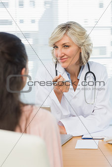 Friendly female doctor in conversation with patient