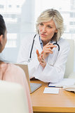 Female doctor listening to patient with concentration
