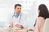 Doctor listening to patient with concentration at desk