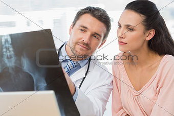 Male doctor explaining xray report to patient
