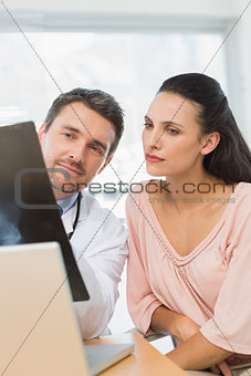 Male doctor explaining xray report to a patient