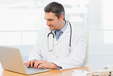 Doctor working on laptop at medical office