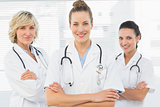 Three confident female doctors with arms crossed