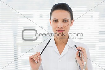Beautiful confident female doctor with stethoscope