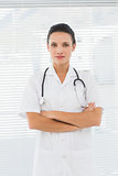 Beautiful female doctor standing with arms crossed