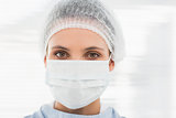 Female surgeon wearing surgical cap and mask