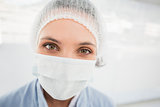 Female surgeon wearing surgical cap and mask