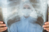 Female surgeon examining blurred xray