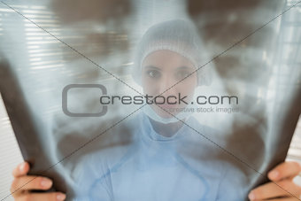 Female surgeon examining blurred xray