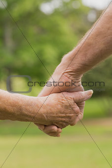 E lderly couple holding hands