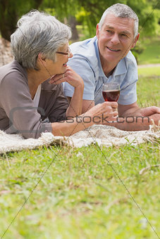 Senior couple lying at the park