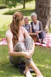 Woman with grandmother and granddaughter in background at park