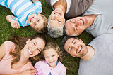 Extended family lying in circle at park