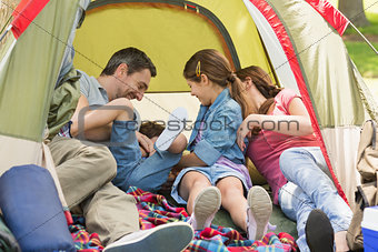Family sitting in the tent at park