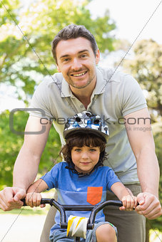 Man teaching his son to ride a bicycle