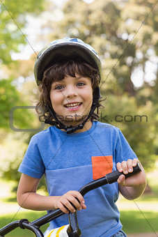 Cute little boy wearing bicycle helmet