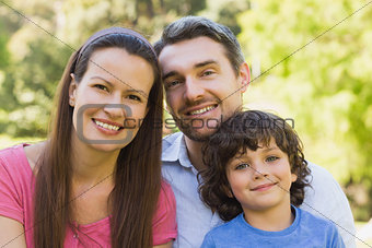 Closeup of a smiling couple with son in park