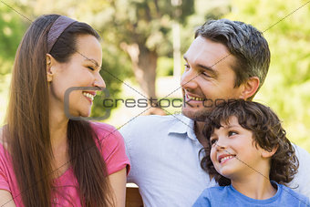 Smiling couple with son in park